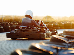 Two people go karting on an outdoor track