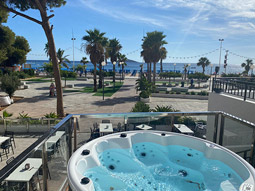 A private jacuzzi on a balcony that overlooks the beach and sea in Benidorm