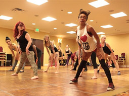 A group of woman learning how to twerk at a twerking dance class