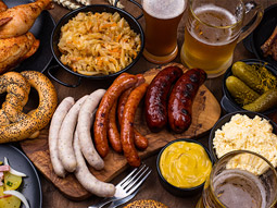 German style food on a table with wooden boards and beers