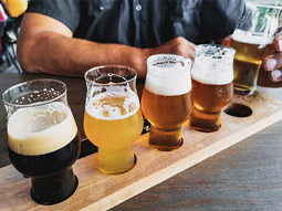 A line of beers on a wooden board at a beer tasting day in Madrid
