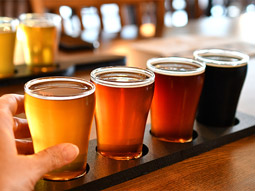 A selection of different beers on a wooden plank to taste and test in Lisbon