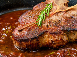 A close up of a steak with seasoning on at a hen dinner in Lisbon
