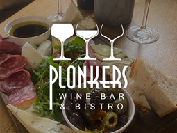 The Plonkers logo overlaying an image of a cheese board at Plonkers in York