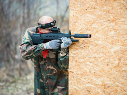 Someone playing combat laser with orange lighting behind him at Outdoor Laser Combat in Madrid