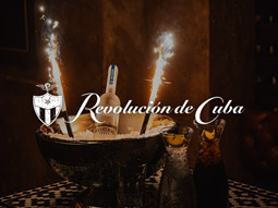 A bucket with alcohol and ice in with the Revolucion de Cuba logo overlayed