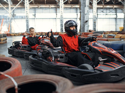 Two people in go karts about to race indoors in Bucharest
