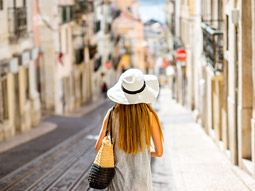 A woman exploring the city of Lisbon on a tour
