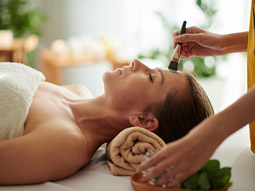 A woman getting a face treatment at a spa day in Lisbon