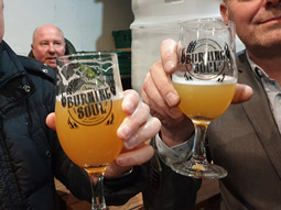 Two people with pints in their hands at a Liverpool Brewery Tour