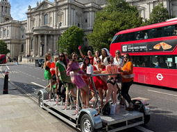 A group of girls on a party bike tour around London