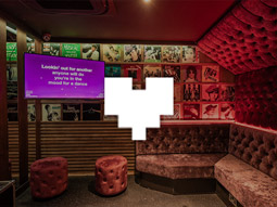 A karaoke booth with a screen and microphone at Lucky Voice Karaoke Night in London