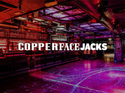 An open space with pink lighting and the Copper Face Jacks logo overlayed