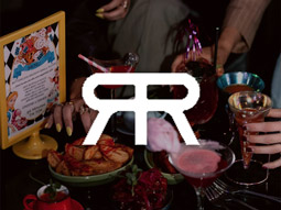 Cocktails and food on a table with the River Rooms logo overlayed
