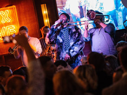 A band performing on stage in front of a crowd at Box