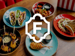 Plates of food on a wooden table at Fridays