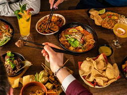 A table laid out with various dishes of food at Banana Tree in London