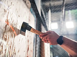 An axe that has been thrown and has hit the bullseye on a wooden block at Axe Throwing in Berlin
