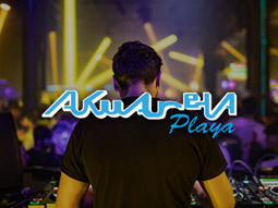 A DJ with his back towards the camera, playing a set at Akuarela in Valencia