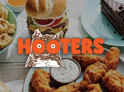 Different items of food on tables with the Hooters logo overlayed