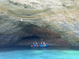 Two boats entering a cave on the Benagil Cave Boat Tour in Algarve
