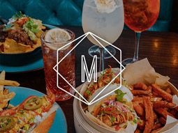 Different food dishes and drinks on a table at Manahatta