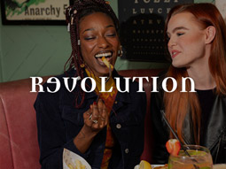 Two girls eating brunch food at Revolution