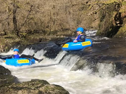 People in rubber dinghys at White Water River Tubing