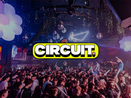 People on a dance floor with cool lights above it at Circuit