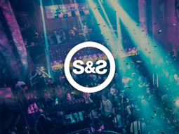 The dance floor and bar lit with blue and purple lights at Steinbeck & Shaw