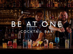 Two women making a variety of cocktails at Be At One