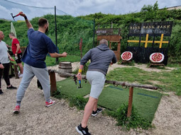 A group of people throwing axes at a target at Country Games in Split 