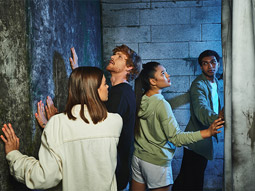 A group of people trying to work out an escape room