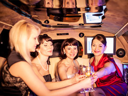 A group of people clinking drink glasses in a limousine in Split
