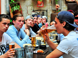 Three men holding a beer each