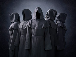 Five people wearing dark cloaks that cover their faces at The Traitors Backstabber Village game