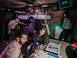 A group of people working out puzzles in an escape room
