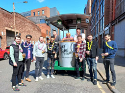 A group of men on a beer bike drinking beer