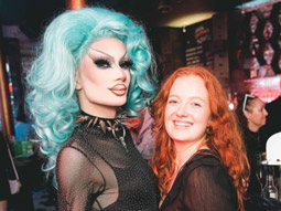 A girl posing with a drag queen on a Drag Queen Bar Crawl