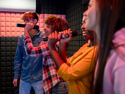 People singing and performing at karaoke