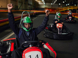 People racing around a track in go karts