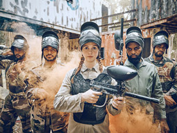 A group of people dressed in camouflage at paintballing