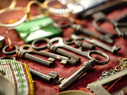 A selection of different keys and objects on a table at an escape room