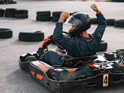 Someone on a kart with his arms in the air