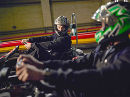 Two men go karting side by side 