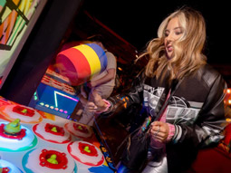 A woman at Play Fayre playing Whack a Mole 