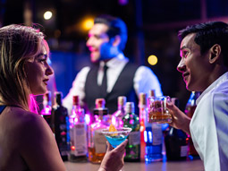 A man and a woman sat at a bar 