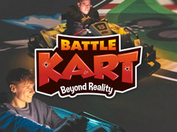The Battle Kart logo layered over two men racing go karts on a Mario Kart style track 