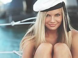 A naked woman wearing a sailor's hat