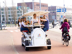 A stag group riding on a beer bike in Amsterdam